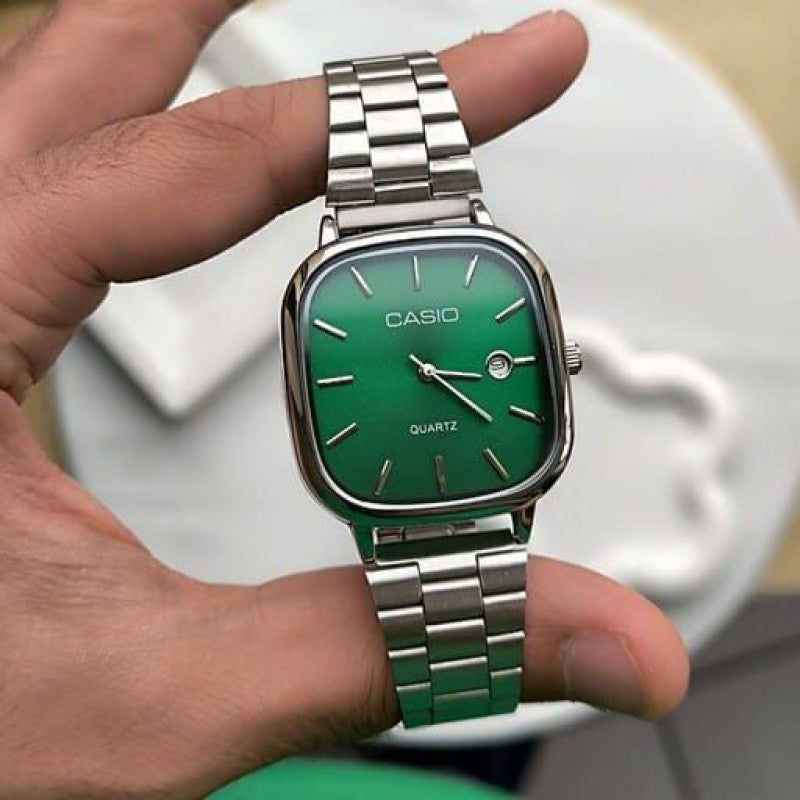 Casio Quartz Classic Watch with green dial and silver stainless steel bracelet held in hand