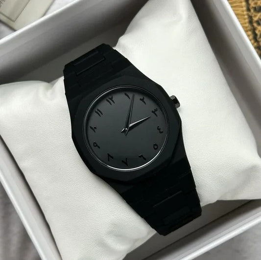 Black watch on a white cushion inside a box
